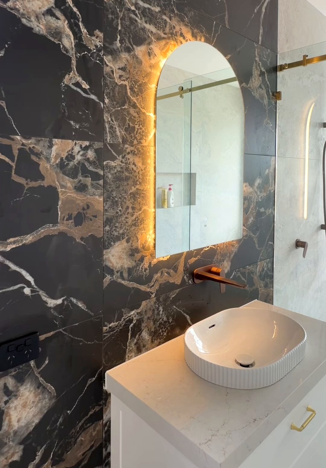 Marble vanity and bathroom lighting